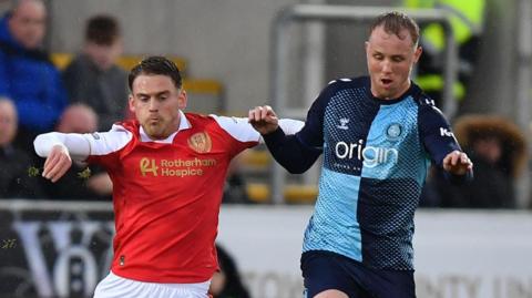 Rotherham United midfielder Josh Benson and Wycombe Wanderers defender Jack Grimmer battle for the ball