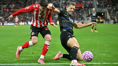 Sunderland's Trai Hume challenges Everton's James Tarkowski 