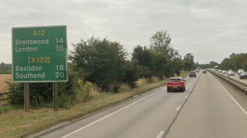 Part of the A12 in Essex at junction 19 Boreham. The road is two lanes of dual carriageway. A green sign ahead directs motorists to the A12 of Brentwood and London and the A130 Basildon and Southend.