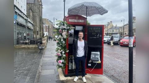 Jonathan Parsons standing outside his ice cream shop