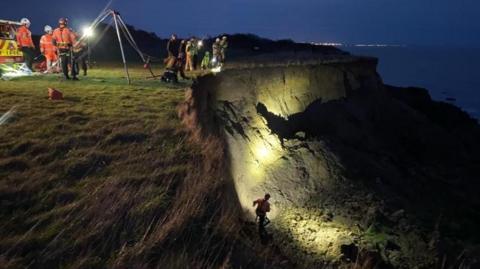 Firefighters on the cliff edge