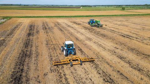 Tractors sowing seeds