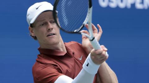 Jannik Sinner hits a forehand