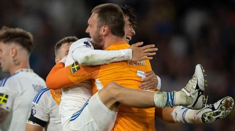 Ao Tanaka of Leeds United celebrates with goalkeeper Lucas Perri 