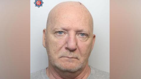 A mugshot of Terrence King who is staring directly at the camera with no expression on his face
