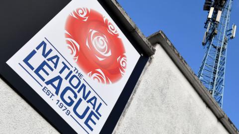 A National League sign and floodlight