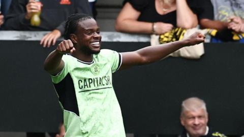 Millenic Alli celebrates a goal