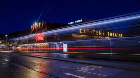 A night time photo of the exterior of the building when they were testing the new neon lighting.