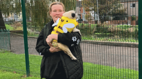 Sally Brien and her dog Molly standing near the River Freshney in Grimsby