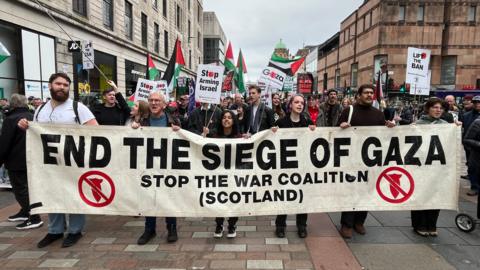A group of pro-Palestine protesers marching through Glasgow City Centre on Saturday.