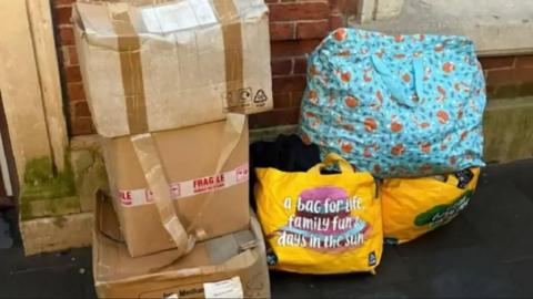 Image of 'fly-tipping' outside the Magic Cottage Charity Shop. 