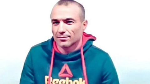 Mojahed Kourkouri smiles at the camera wearing a Reebok hoodie