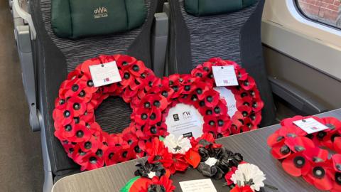 Poppy wreaths are laid on seats on a train as they are taken from Gloucester station to London Paddington to mark Armistice Day. 