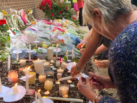 Residents light candles as they gathered to remember Bhim Kolhi