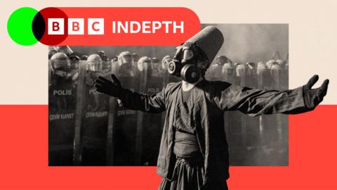 A protester wearing a whirling dervish costume performs in front of Turkish riot police barricades