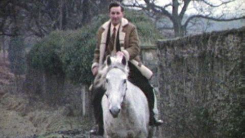 A man riding a white horse