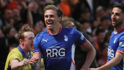 Joe Pritchard celebrates scoring for Oldham