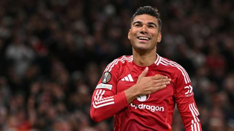 Casemiro celebrates for Manchester United by placing his palm over the club badge on his shirt