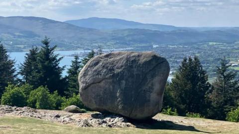 A view of Cloughmore (the Big Stone) from Slieve Martin, overlooking Carlingford Lough and the Cooley Mountains in the distance. Cloughmore is a huge boulder that sits on the slope of the mountain.