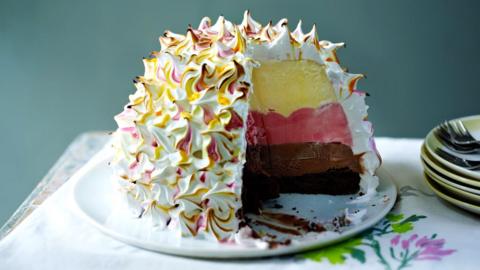 Baked Alaska pudding, with yellow, pink and brown filling.