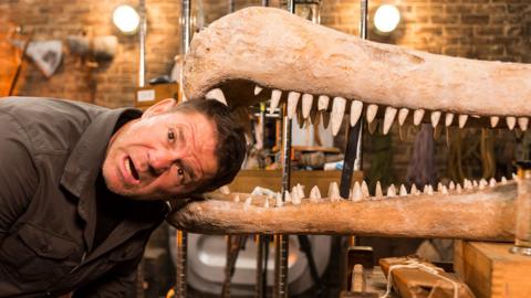 Steve Backshall has put his head in the skeleton jaws of a dinosaur