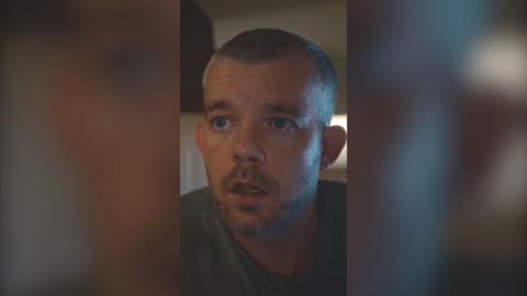 A man with a buzz cut looks shocked with his mouth agape