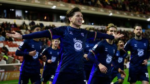 Adam Reach celebrates