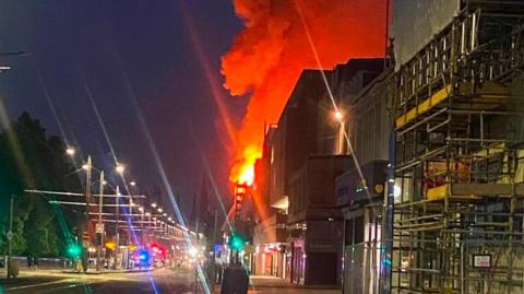 A fire at a building on a city centre street at night