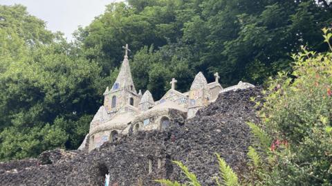 Guernsey's little chapel. It is a small building set in a rock with shells and pot making up the rock