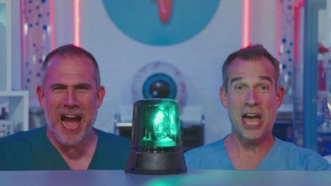 Dr Xand and Dr Chris shout in behind a flashing light