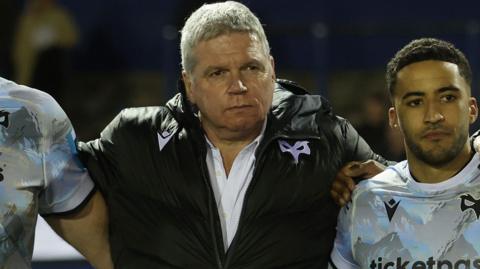Ospreys chief executive Lance Bradley in a huddle with players