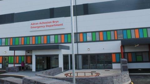 A grey building with an 'Emergency Department' sign in red writing