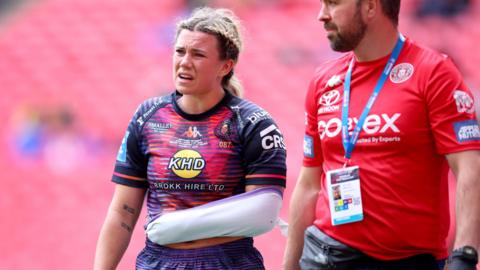 Emily Veivers walks off with her arm in a makeshift sling during Wigan's win over St Helens in Saturday's Women's Challenge Cup final at Wembley
