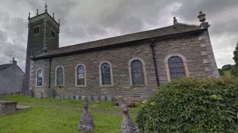 St Anne's is a Georgian single-storey grey-bricked church with a two-storey tower on one side.