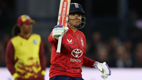 England batter Sophia Dunkley raises her bat after hitting fifty