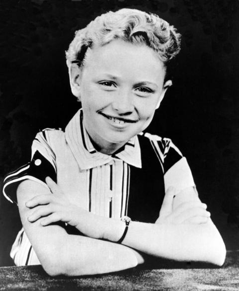 Dolly Parton posing for a photo in 1955.
