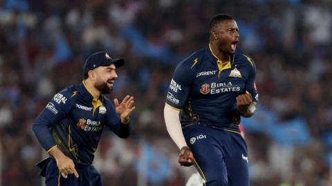 Rashid Khan and Jason Holder celebrate a wicket for Gujarat Titans