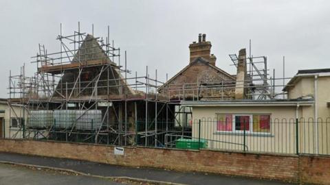 Manorbier School. It has no roof in places and is covered in scaffolding 