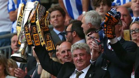 Steve Bruce lifts the Championship play-off final trophy aloft at Wembley in 2016.