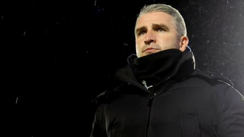 Wigan Athletic boss Ryan Lowe looks on