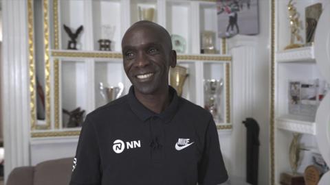 Kipchoge smiling in his house