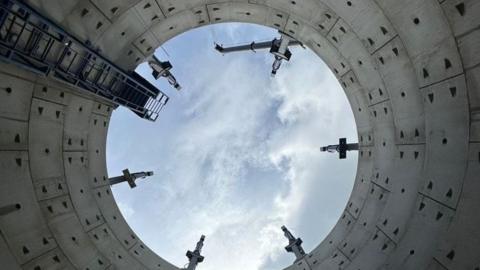 View from the bottom of a storm overflow storage tank looking up to open sky. 