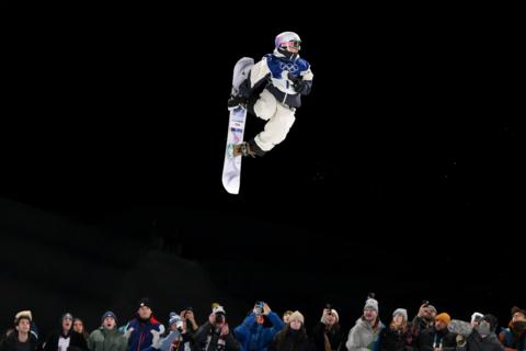Snowboarder against a night sky