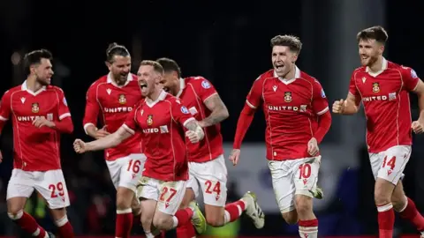 Wrexham players celebrate beating Nottingham Forest