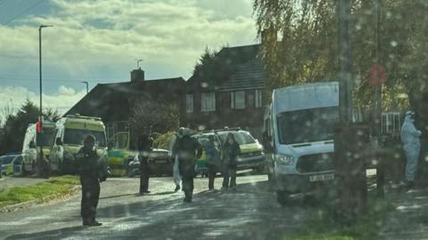 Photo shows a number of forensic and uniformed officers on Curbar Curve in Inkersall. Two police cars and two ambulances can be seen in the picture. 