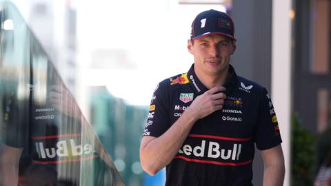 Max Verstappen walks through the Barcelona paddock during media day 