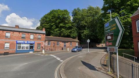 Part of the roundabout on the junction of Bonhay Road and Cowley Bridge Road in Exeter with a sign showing the route towards the M5