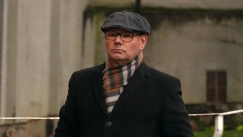 Richard Crisp, wearing glasses and a flat cap, outside Sheffield Magistrates' Court.