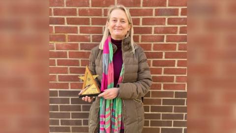 Lorna Berrett with her award