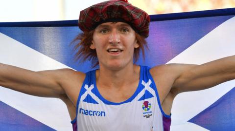Jake Wightman with a Scottish flag